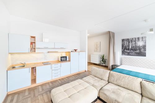a living room with a couch and a bed at Apartament 502 in Kaunas