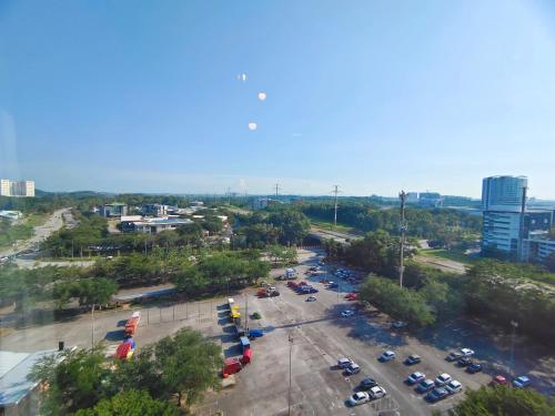 an aerial view of a parking lot in a city at Kanvas Soho Cyberjaya/Netflix/Gym/Jacuzzi/KLIA in Cyberjaya