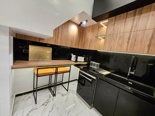 a kitchen with a counter and a bar in it at New Cairo's Poolside Oasis in New cairo