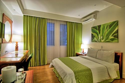 a hotel room with a bed and a desk at Balmoral Hotel San José CR, Historic District in San José