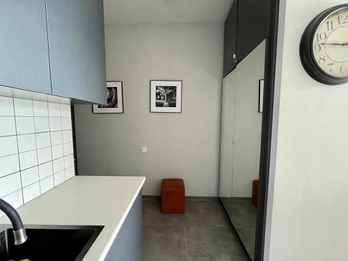 a kitchen with a counter and a clock on the wall at Graz Narek house 2 in Altenfelden