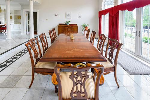 a dining room with a wooden table and chairs at Mulgrave Mansion in Mulgrave