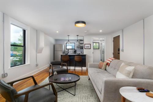 a living room with a couch and a table at Cherry Street Loft (A) Pet-Friendly & In the Heart of Downtown Black Mtn! in Black Mountain