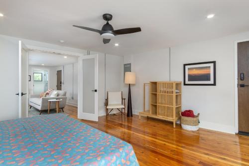 a bedroom with a bed and a living room at Cherry Street Loft (A) Pet-Friendly & In the Heart of Downtown Black Mtn! in Black Mountain