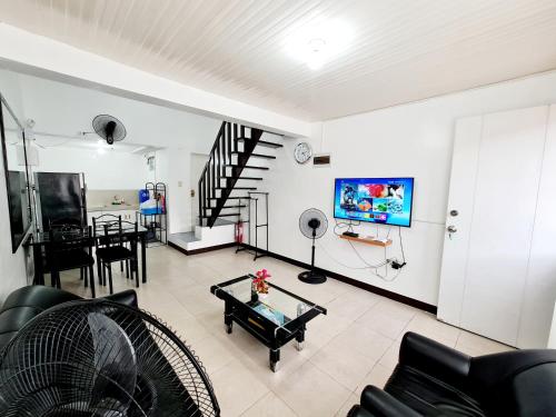 a living room with a couch and a table at Vacation Transient Guest House Rental Calapan City L43 in Calapan