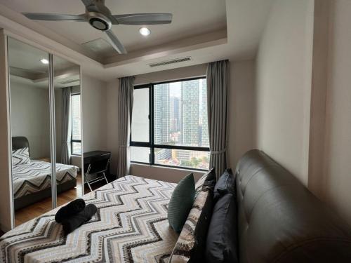 a bedroom with a couch and a large window at BBHomes at Casa Residency KL in Kuala Lumpur