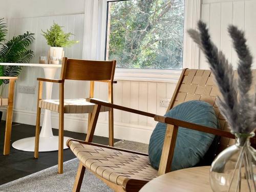 a living room with two chairs and a table at Gloucester Serviced Apartments in Gloucester