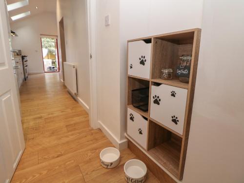 a hallway with a book shelf in a house at Croft Cottage in Castleton
