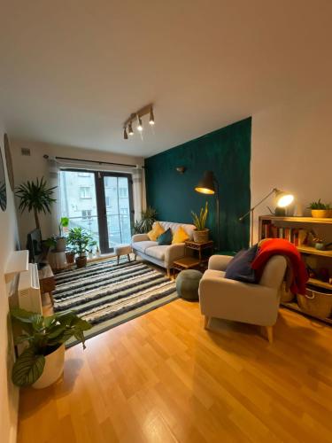 a living room with two couches and a rug at Cosy Modern Apartment in Portobello in Dublin
