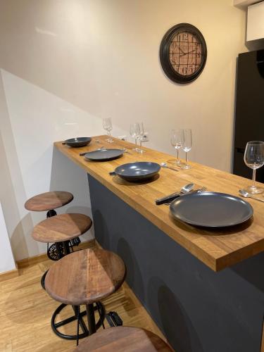a table with plates and wine glasses on it at Aix-en-Provence, studio atypique quartier hyper centre in Aix-en-Provence