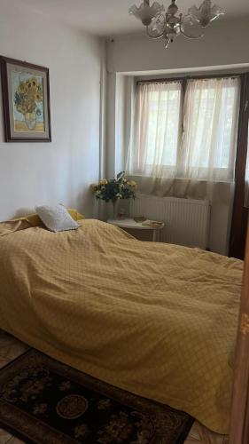 a bedroom with a bed with a blanket on it at Elegant Boem Apartment in Focşani