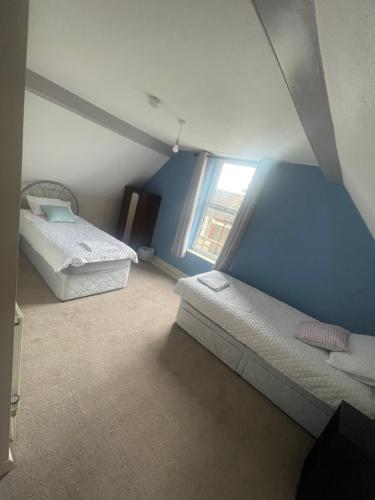 a bedroom with two beds and a window at Ninian Park Road in Cardiff