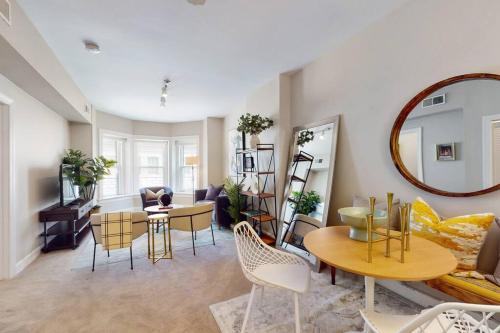 a living room with a table and chairs and a mirror at River North Deltee in Chicago