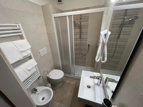 a bathroom with a sink and a toilet and a mirror at Le Camere dei Magi in Saturnia