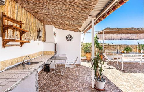 an outdoor kitchen with a sink and a table at Casa Triana in Cuevas del Campo
