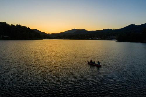 a group of people in a boat on a lake at Lower Lakeshore Living in Lake Junaluska