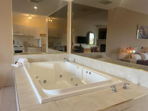 a large white bath tub in a room at Western Budget Motel Ponoka in Ponoka