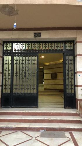 an entrance to a building with a black gate at Smoha Zahran Haus (Private rooms or Private Apartment) in Alexandria