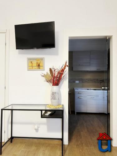 a vase of flowers on a table in a kitchen at Guest House La Maddalena in Foggia