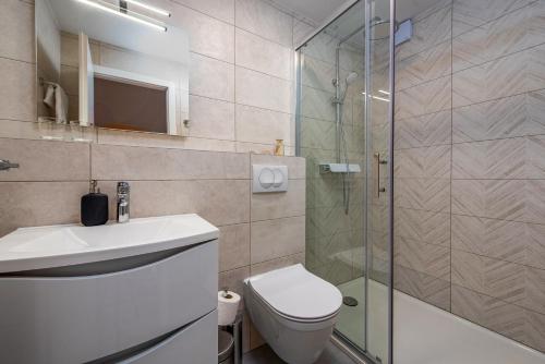 a bathroom with a shower and a toilet and a sink at Dalmor holiday house in Rovanjska