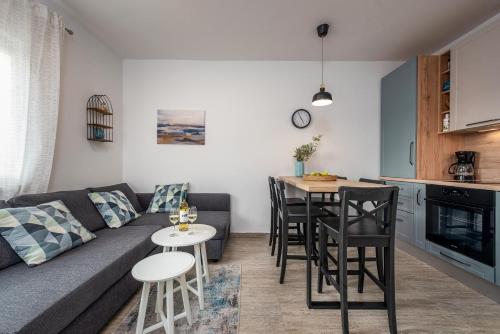 a living room with a couch and a table at Dalmor holiday house in Rovanjska