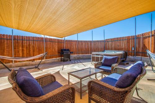 a screened in porch with chairs and a table at Cacti Sanctuary in Sunfair Heights