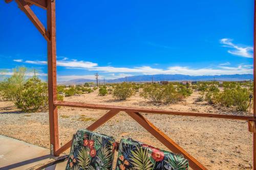 two chairs sitting on a porch in the desert at Cacti Sanctuary in Sunfair Heights
