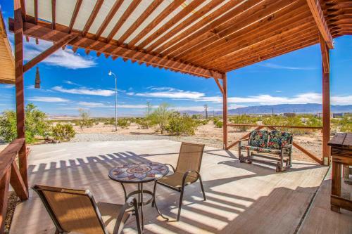 a patio with a table and chairs and a view of the desert at Cacti Sanctuary in Sunfair Heights