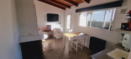 a living room with a table and a window at Aime in Esquel