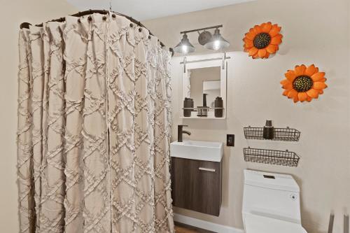 a bathroom with a shower curtain and a sink at Desert Serenity in Yucca/Joshua Tree w/AC & Fire pit in Yucca Valley