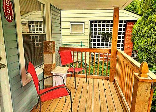 a porch with two chairs and a table on a deck at *All-American Home Minutes From Case/UH/Cle Clinic in Cleveland Heights