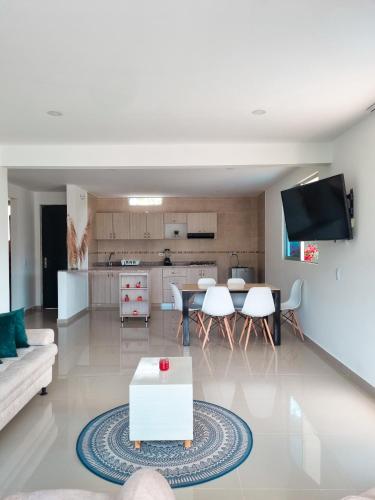 a living room with a couch and a table at Penthouse Anapoima Centro con jacuzzi privado in Anapoima