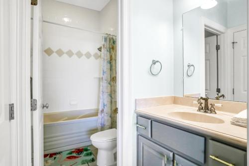 a bathroom with a sink and a toilet and a mirror at Bird's Eye View in St. George Island