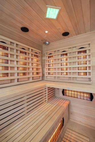 an empty sauna with wood paneling and a wooden ceiling at Villa Alison Deluxe Junior with private spa and heated swimming pool in Nedeščina