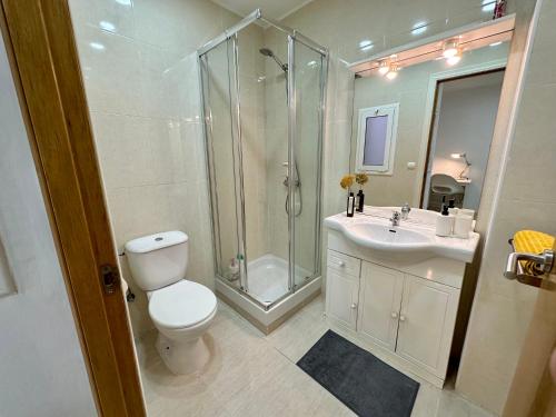 a bathroom with a shower and a toilet and a sink at Little Horse apartments 3 in Tarragona