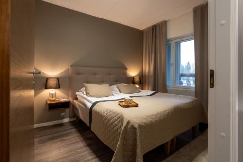 Кровать или кровати в номере Vuokatti Booking Suites
