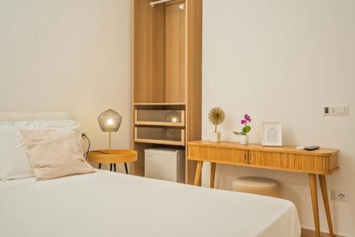 a bedroom with a bed and a wooden desk at infinity Castellabate b & b di Charme in Santa Maria di Castellabate