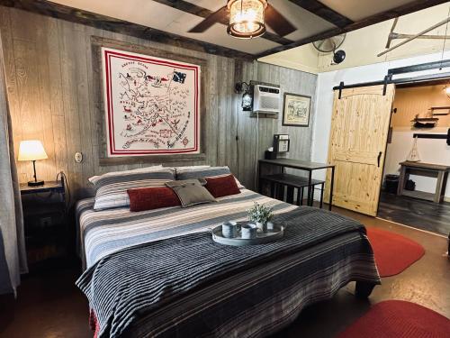 a bedroom with a large bed and a table at Acorn Hideaways Canton Gold Panner Bunkhouse King Bed in Canton