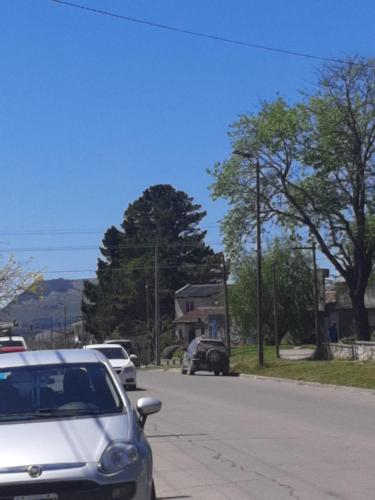 a white car parked on the side of a street at Apart Los Cerrillos in Balcarce