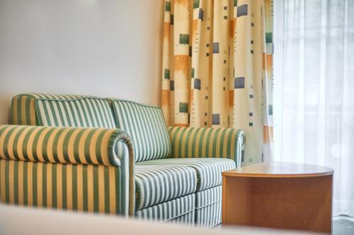 a living room with a chair and a table at Alpenaussicht in Obergurgl