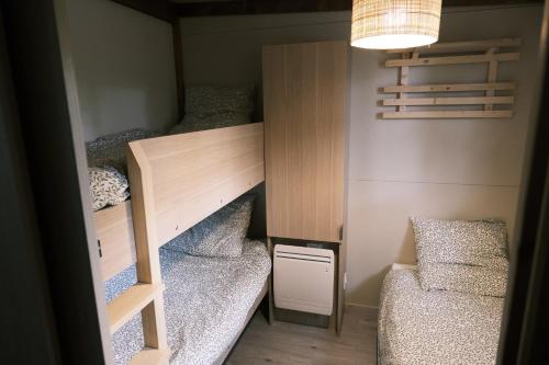 a small room with two bunk beds and a couch at Lodge avec SPA privatif - Foret et Lac in Liginiac