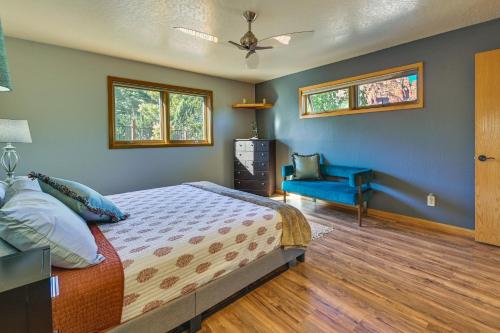 a bedroom with a bed and a blue chair at Peaceful Sedona Home - Walk to Amitabha Stupa! in Sedona