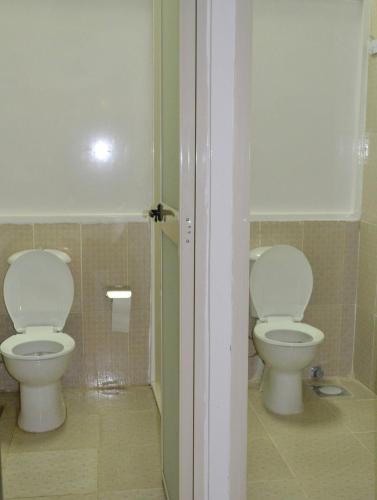 a bathroom with two toilets in a room at Cecilia Hostel in Cairo