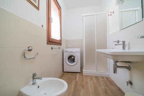 a bathroom with a sink and a washing machine at Casa al Mare in Capoliveri