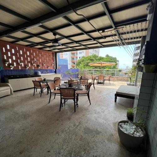 a patio with tables and chairs on a building at STUDIO 204 | WIFI 600MB | RESIDENCIAL JC, um lugar para ficar. in Belém