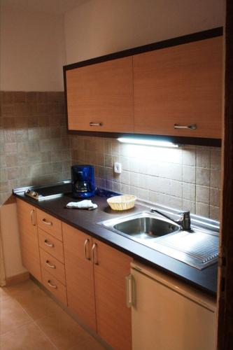 a kitchen with a sink and a counter top at Apartamentos Matorral in Morro del Jable