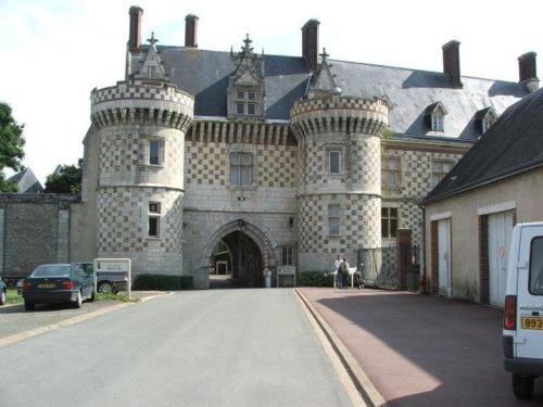 a large stone building with a gate in front of it at Duplex de 65 m2, Cœur de Bonneval in Bonneval