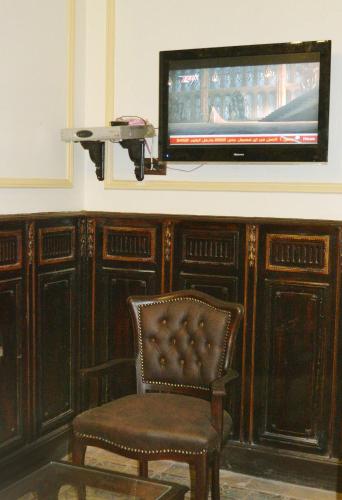 a chair and a television in a room at Cecilia Hostel in Cairo