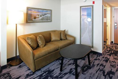 a living room with a couch and a table at Fairfield Inn & Suites by Marriott Charleston Airport/Convention Center in Charleston