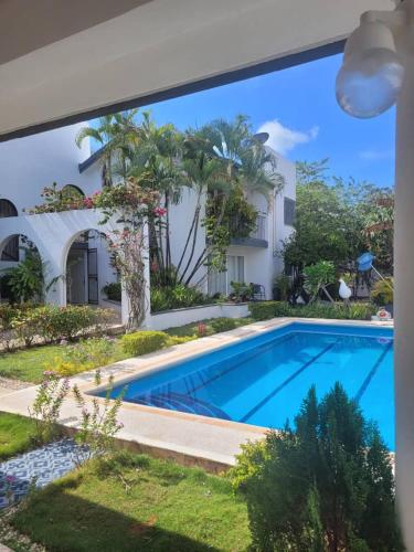 a swimming pool in front of a house at Villa Lol-Ha in Cancún